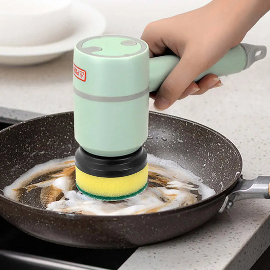 Electric cleaning brush in use on a frying pan, showcasing its multifunctional scouring pad and ergonomic design.